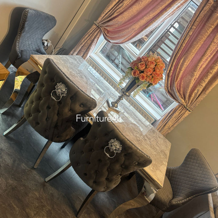 Dining room with a table and chairs near a window with floral decorations.