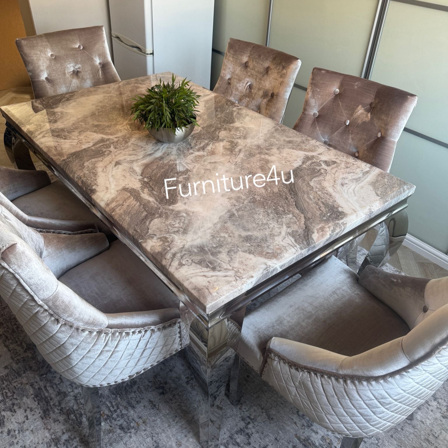 Dining table set with marble-like surface and chairs in a room setting.