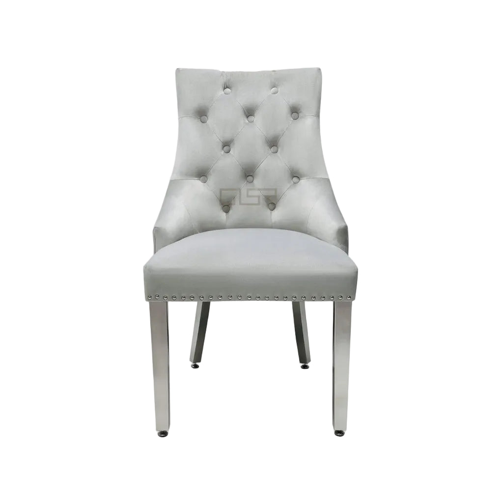Gray tufted chair on a white background