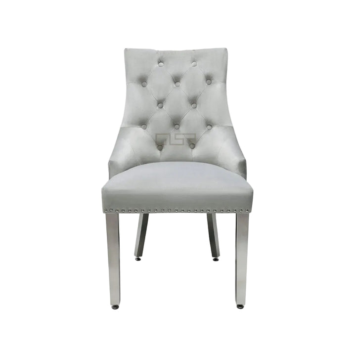 Gray tufted chair on a white background
