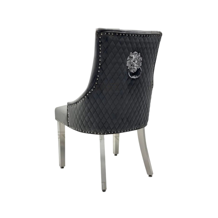 Gray quilted chair with lion emblem on a white background